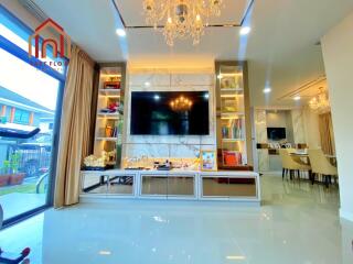 Modern living room with chandelier and built-in entertainment center