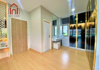 Modern bedroom with vanity area and wooden flooring