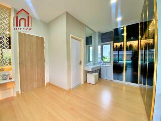 Modern bedroom with vanity area and wooden flooring