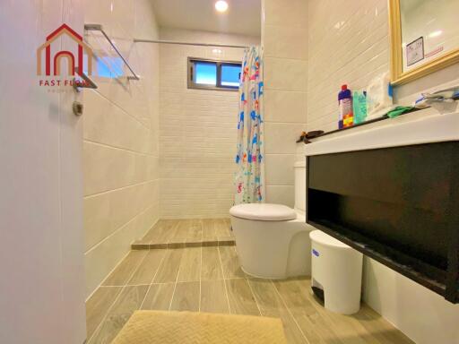 Modern bathroom with tiled flooring and shower area