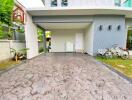 Covered driveway with bicycles and greenery