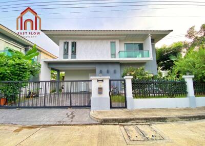 Modern two-story house with a front yard and gated driveway