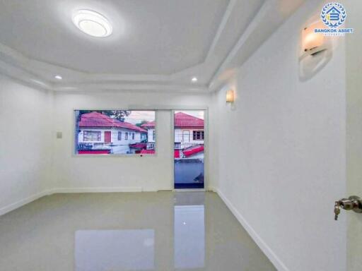 Modern living room with polished floor and large window