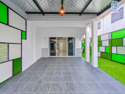 Modern garage area with tiled floor and colorful glass panels