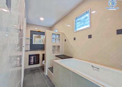 Modern bathroom with large bathtub and glass partitions