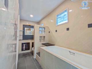 Modern bathroom with large bathtub and glass partitions