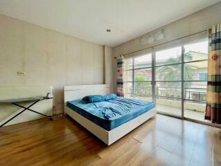 Spacious bedroom with large window and balcony access