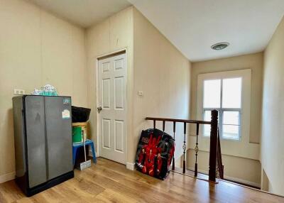 Hallway with refrigerator and stairs