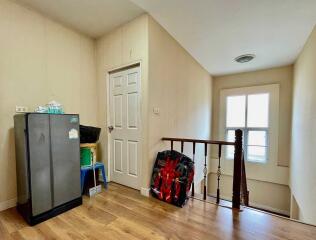 Hallway with refrigerator and stairs