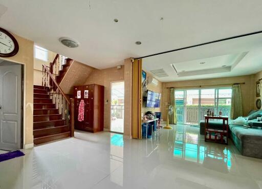 Spacious living area with staircase and modern decor