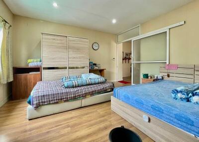 Spacious bedroom with twin beds, ample storage, and natural light