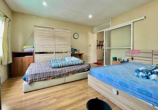 Spacious bedroom with twin beds, ample storage, and natural light