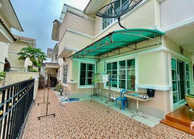 Exterior view of a residential building with a tiled patio