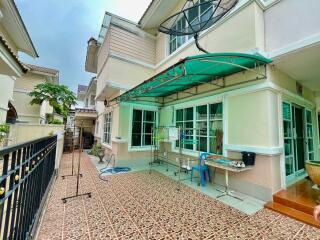 Exterior view of a residential building with a tiled patio