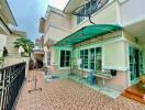 Exterior view of a residential building with a tiled patio