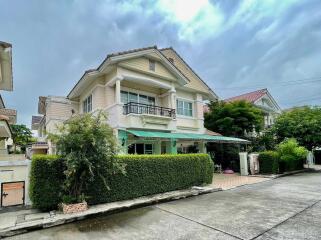 Two-story residential house with greenery