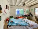 Bedroom with bed, desk, and window light