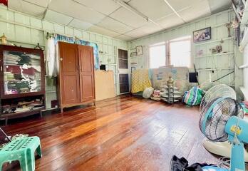 Spacious bedroom with wooden floors and natural light