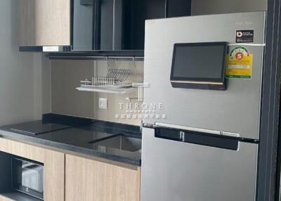 Modern kitchen with refrigerator and built-in cabinets