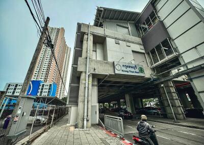 Exterior view of a modern urban building with a rider on a motorbike