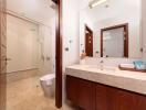 Modern bathroom with glass-enclosed shower and wooden cabinetry