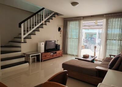 Living room with stairs and large windows