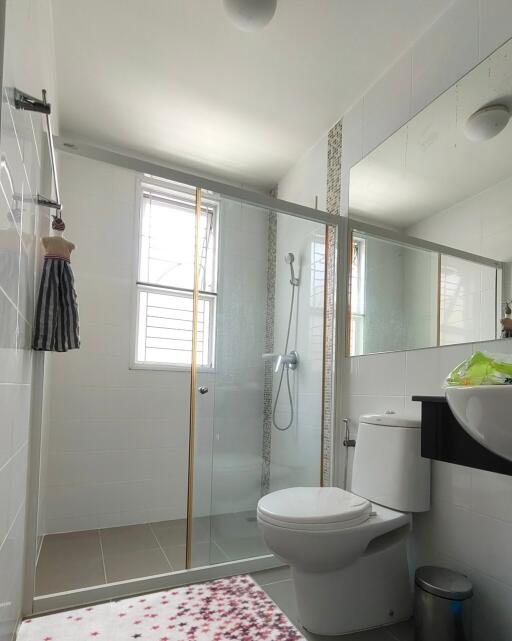 Modern bathroom with glass shower and white fixtures