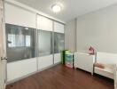 Bedroom with wooden floor and storage space