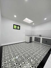 Modern kitchen with patterned tile floor and skylight