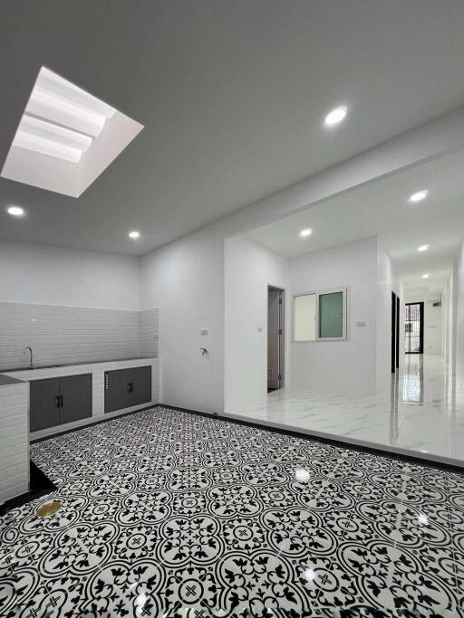 Modern kitchen with black and white patterned floor