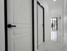 Hallway with white doors and marble floor