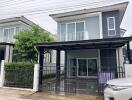 Modern two-story house with carport and small front yard