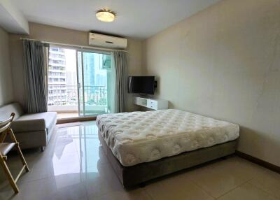 Spacious bedroom with large window and balcony