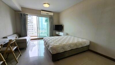 Spacious bedroom with large window and balcony