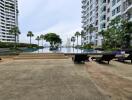 Outdoor pool area with loungers and high-rise buildings