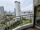 City view from balcony with river and high-rise buildings