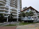 Exterior view of residential buildings with palm trees and parking area