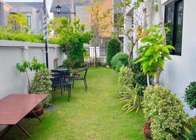 Well-maintained garden with dining area and greenery