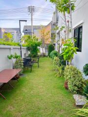 Well-maintained garden with dining area and greenery