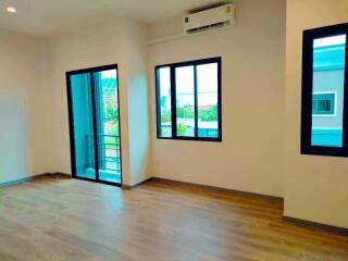 Spacious living room with large windows and balcony access