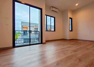 Spacious living room with large windows and modern flooring