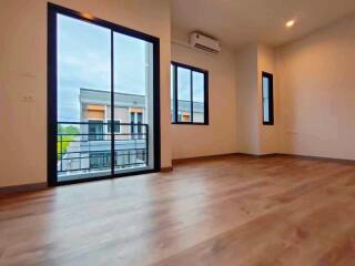 Spacious living room with large windows and modern flooring