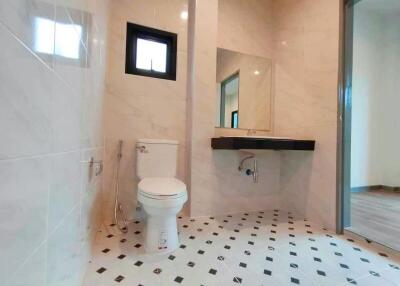 Modern bathroom with large mirror and checkered tile floor