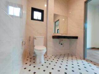 Modern bathroom with large mirror and checkered tile floor