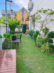 Well-maintained backyard garden with seating area