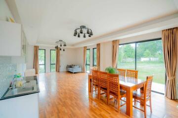 Spacious open-plan living and dining area with large windows