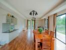 Spacious dining area with wooden table, chairs, and adjacent kitchenette