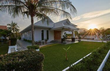 Modern house with a well-maintained lawn at sunset