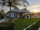 Modern house with a well-maintained lawn at sunset