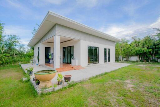 Exterior view of a modern single-story house with garden